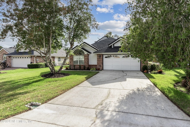 view of front of home with a front yard and a garage