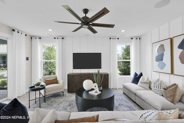 living room with ceiling fan and a healthy amount of sunlight