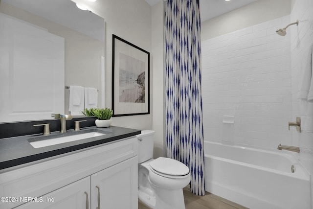 full bathroom featuring vanity, hardwood / wood-style floors, toilet, and shower / bathtub combination with curtain