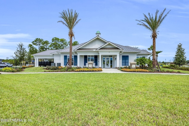 view of front of property with french doors and a front lawn