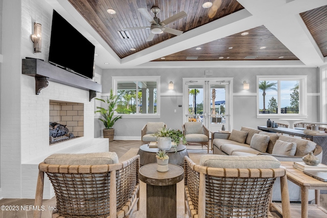 living room featuring light wood-type flooring, ceiling fan, wooden ceiling, a fireplace, and french doors