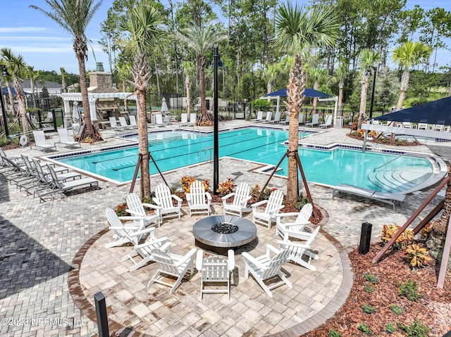 view of pool with a patio and a fire pit