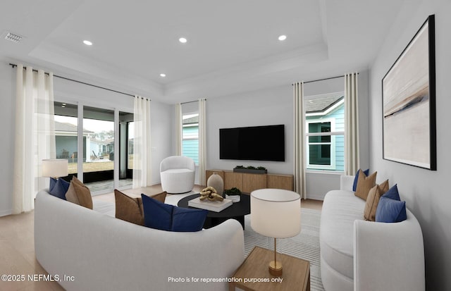 living area featuring visible vents, recessed lighting, light wood-style floors, and a tray ceiling