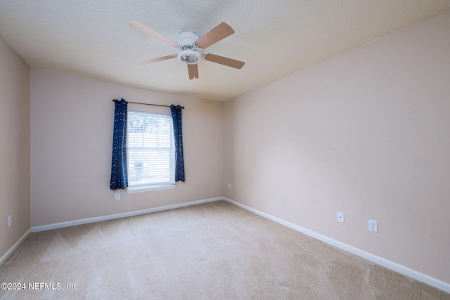 carpeted empty room featuring a textured ceiling and ceiling fan