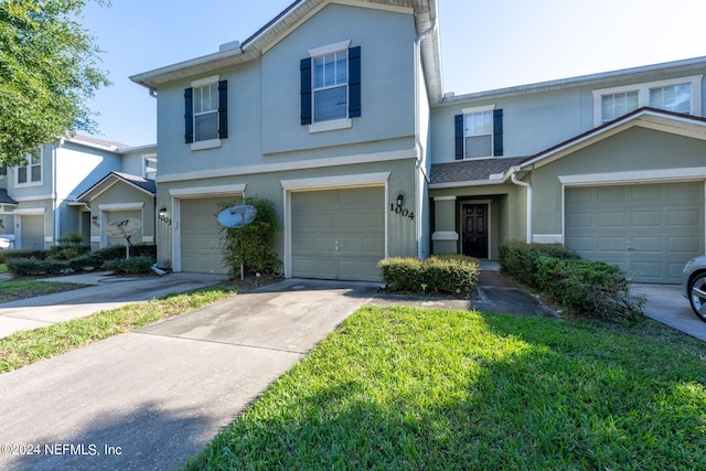 view of front of home with a front yard and a garage