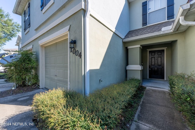 doorway to property with a garage