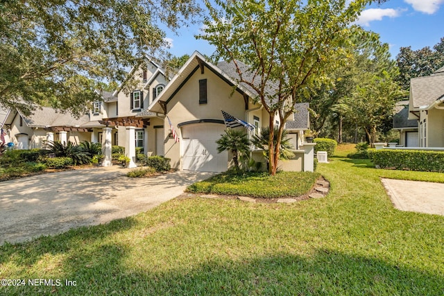 view of front of home with a front yard and a garage