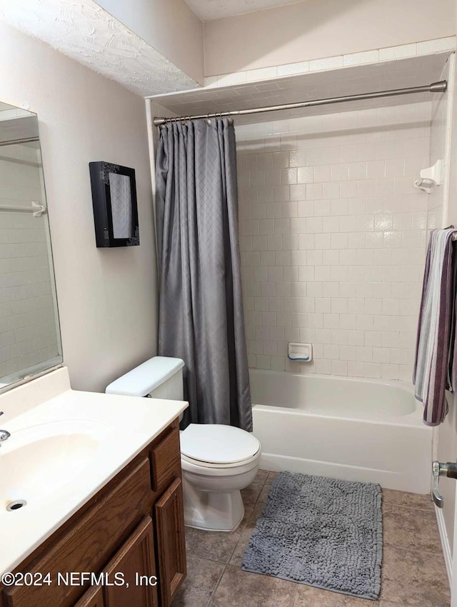 full bathroom featuring vanity, toilet, shower / bathtub combination with curtain, and tile patterned floors