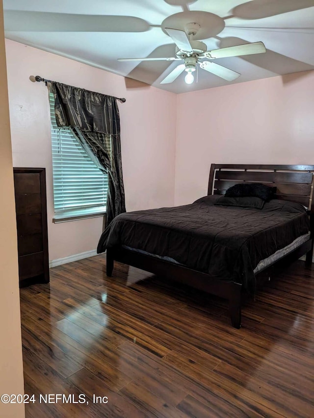 bedroom featuring ceiling fan and dark hardwood / wood-style floors