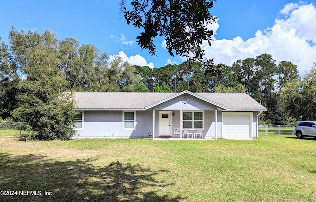 ranch-style house with a front yard, a garage, and covered porch