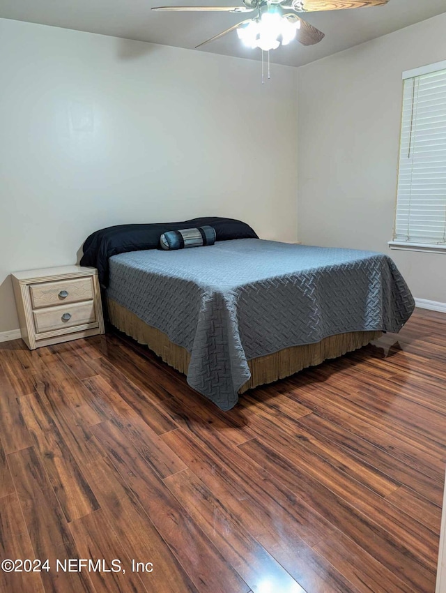 bedroom with ceiling fan and dark hardwood / wood-style floors