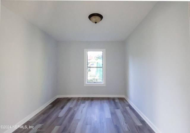 unfurnished room featuring dark hardwood / wood-style flooring