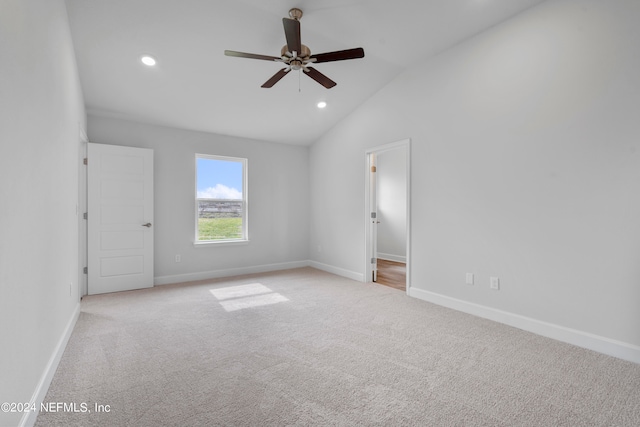 interior space featuring lofted ceiling, ceiling fan, and light colored carpet