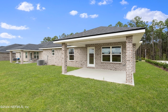 back of house featuring a patio, a yard, and central AC unit