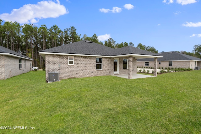 rear view of house featuring central AC, a lawn, and a patio area