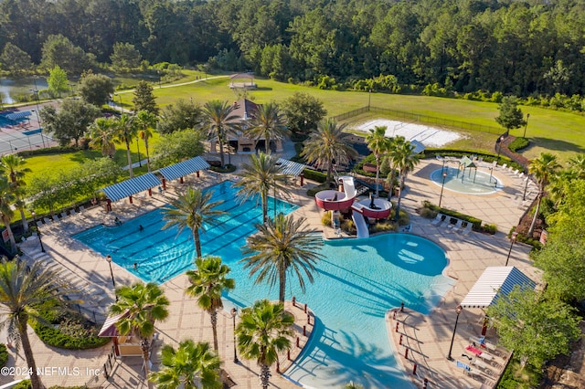 view of swimming pool featuring a water slide and a patio area