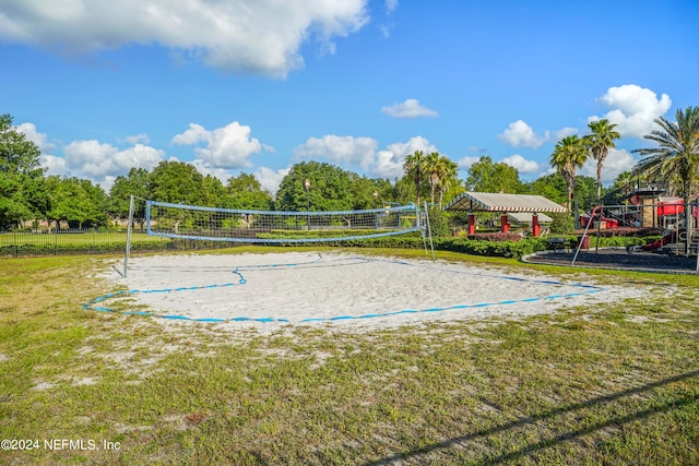 view of community featuring a yard, a playground, and volleyball court