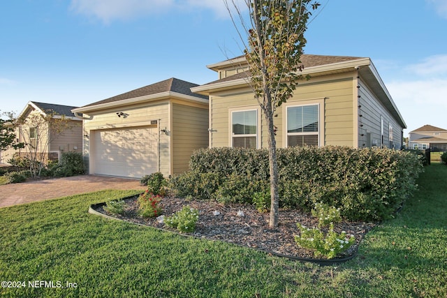 view of front of home featuring a garage and a front lawn