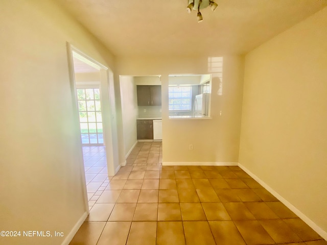 unfurnished room featuring light tile patterned floors and plenty of natural light