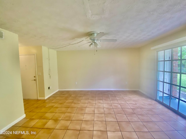 empty room featuring a textured ceiling and ceiling fan