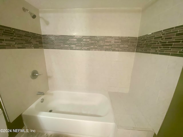 bathroom with tile patterned flooring and tiled shower / bath