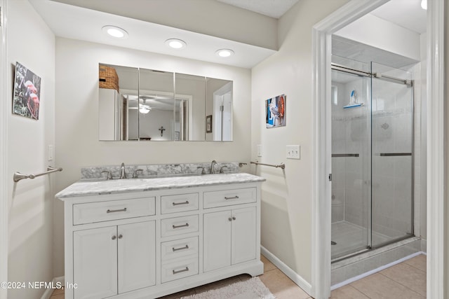 bathroom featuring vanity, ceiling fan, tile patterned floors, and walk in shower