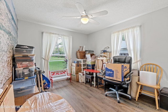 office space with a textured ceiling, hardwood / wood-style flooring, and ceiling fan