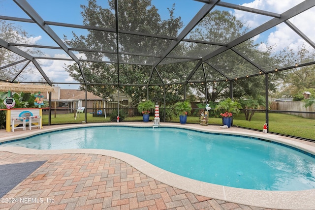 view of swimming pool with a lawn, a patio, and glass enclosure