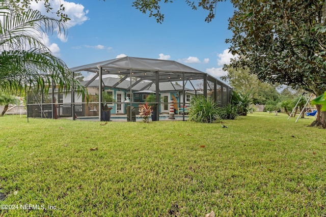 view of yard with a lanai and a swimming pool