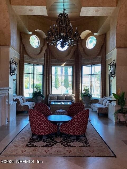 living room featuring a high ceiling and a chandelier