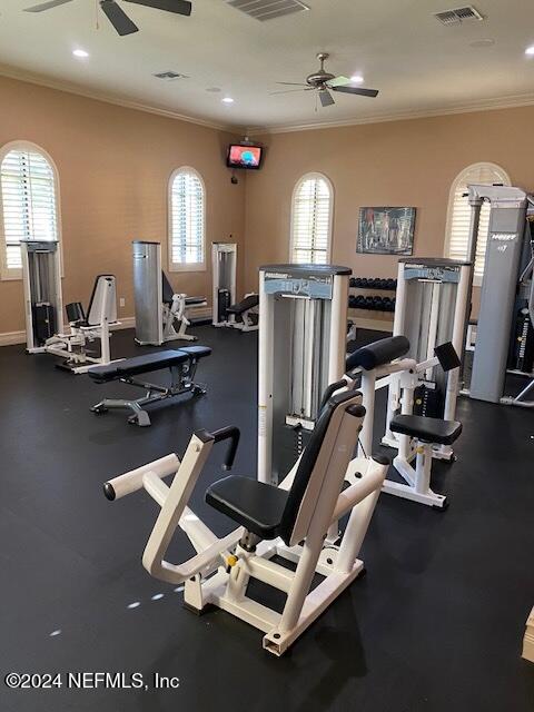 gym with ceiling fan and crown molding