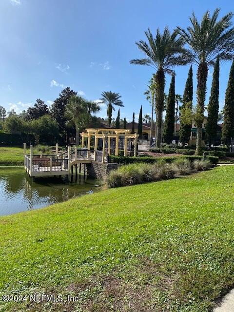 exterior space featuring a water view and a lawn