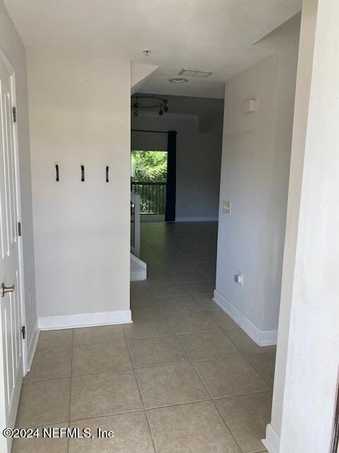 corridor featuring light tile patterned floors