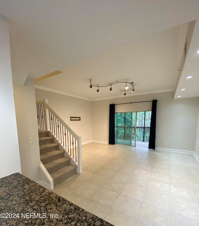 interior space featuring track lighting and crown molding