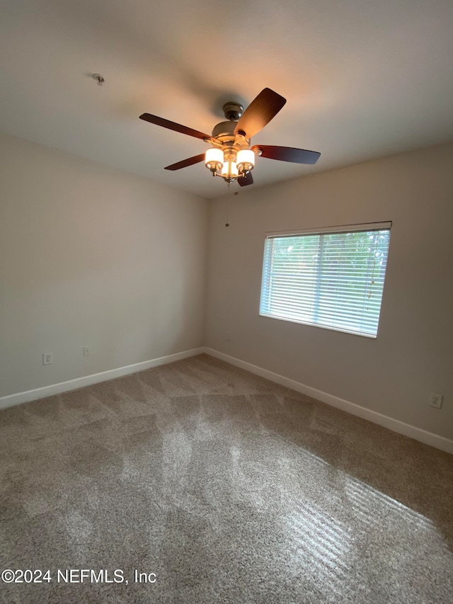 unfurnished room featuring ceiling fan and carpet flooring