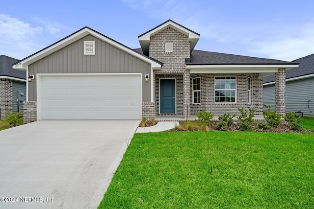 view of front of property featuring an attached garage, driveway, a front yard, and brick siding