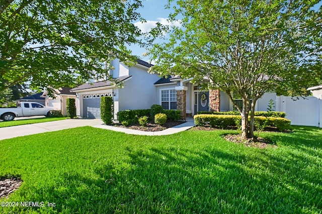 view of front of home featuring a front yard and a garage