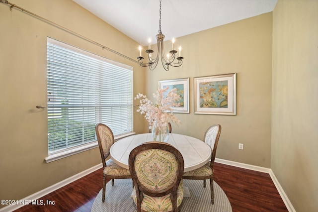 dining space with an inviting chandelier and dark hardwood / wood-style floors