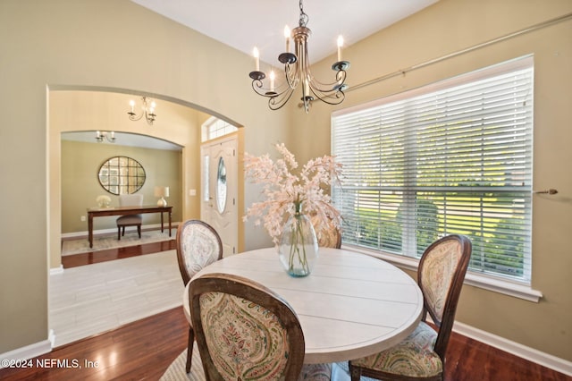 dining room with a notable chandelier, a healthy amount of sunlight, and wood-type flooring