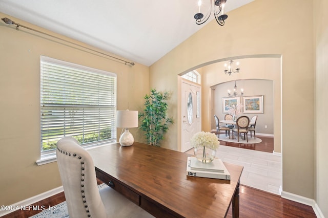 dining room featuring vaulted ceiling, a notable chandelier, and dark hardwood / wood-style flooring