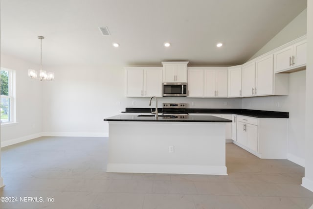 kitchen with white cabinets, sink, a center island with sink, stainless steel appliances, and vaulted ceiling