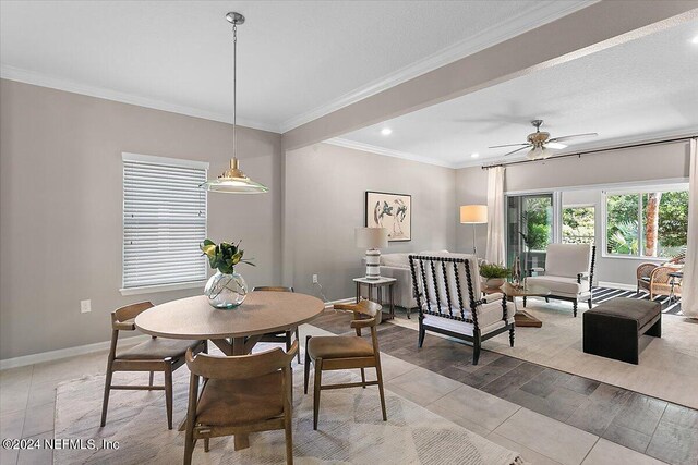 dining room with ceiling fan, ornamental molding, and light hardwood / wood-style floors