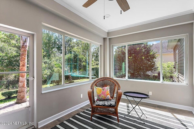 sunroom / solarium featuring ceiling fan