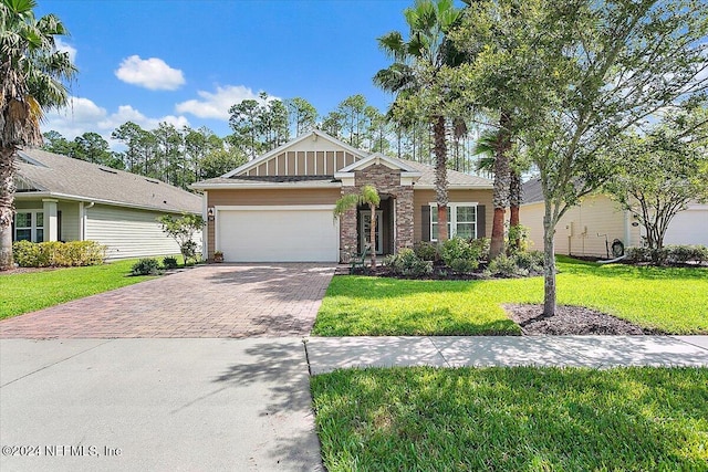 view of front of house with a front yard and a garage