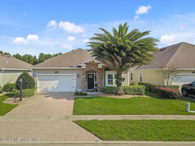 view of front of home featuring a front yard and a garage