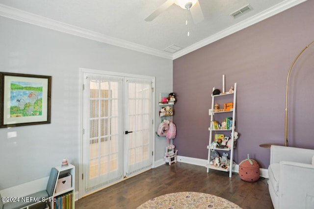 playroom with dark wood-type flooring, ceiling fan, and ornamental molding