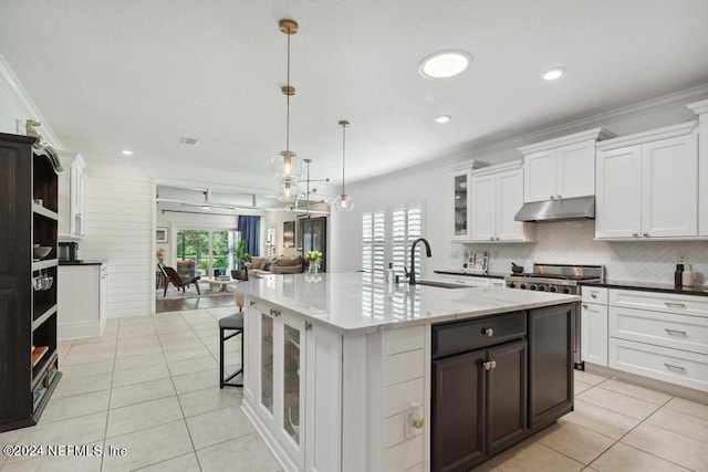 kitchen featuring white cabinetry, crown molding, sink, and decorative light fixtures