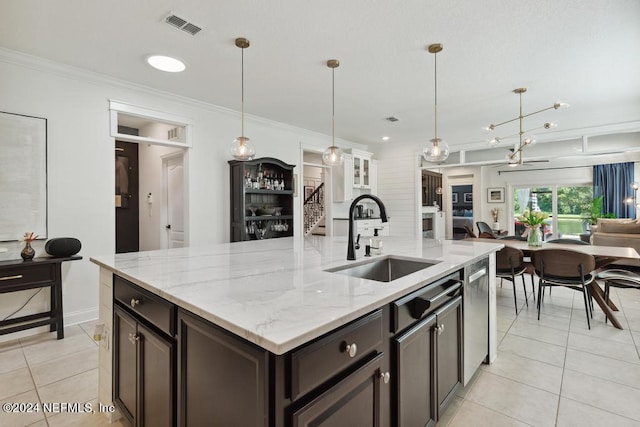 kitchen featuring crown molding, dark brown cabinets, sink, and decorative light fixtures