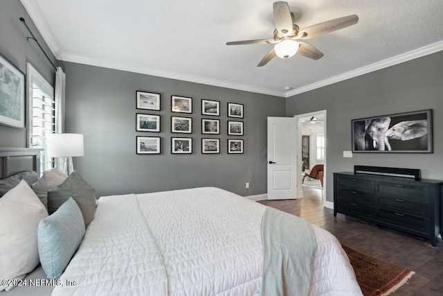 bedroom featuring crown molding, dark hardwood / wood-style floors, and ceiling fan