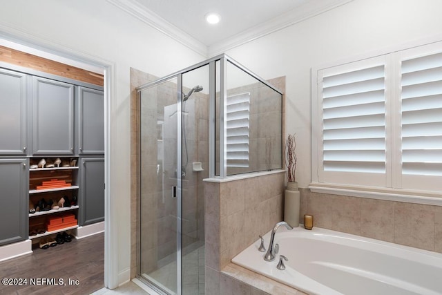 bathroom with crown molding, hardwood / wood-style flooring, and independent shower and bath